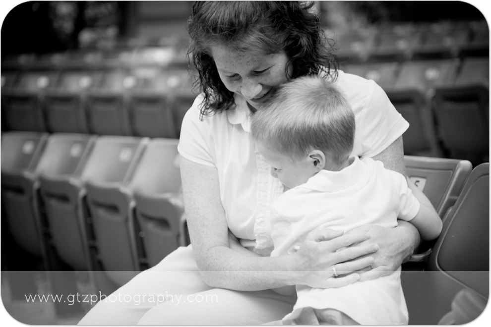 Black and white image of little boy hugging his mommy